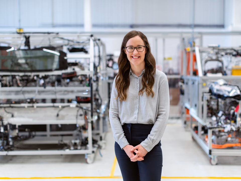 Female automobile industry worker on a production line